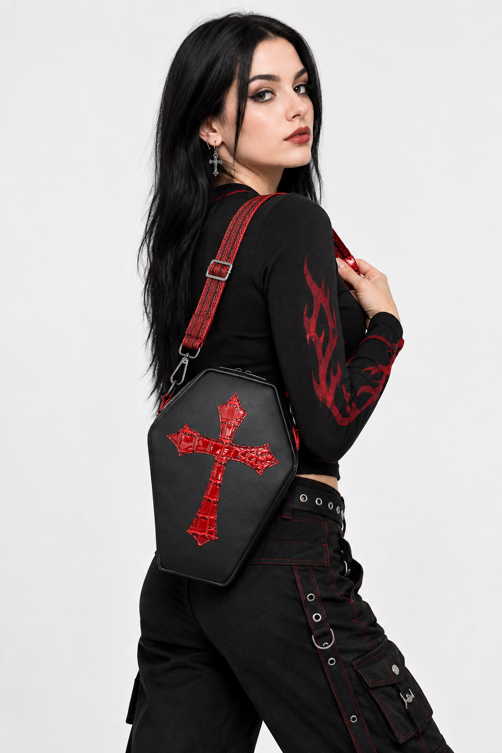 Fun gothic vibe bag in a black vinyl coffin shape bag with blood red croc embellishments.  Black and red one and half inch wide adjustable strap.
