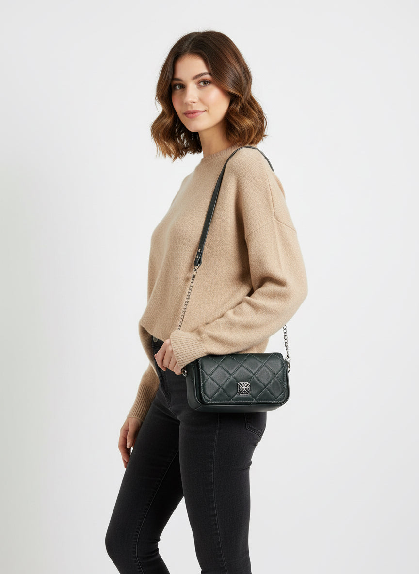 Small bag but enough room for the essentials.  Double magnetic closure, open main compartment with split slip pocket on one side.  Coordinating piping on the front and back.

Beautiful green leather that has been quilted on the diagonal and accented with a Celtic knot on the front flap. Shoulder strap in leather/chain that can be shortened by looping around the chain on each side.