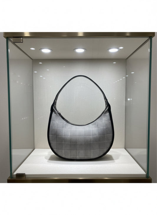 Crescent shaped bag with zipper closure.  Glenellen plaid and black water resistant canvas interior with interior zipper pocket.