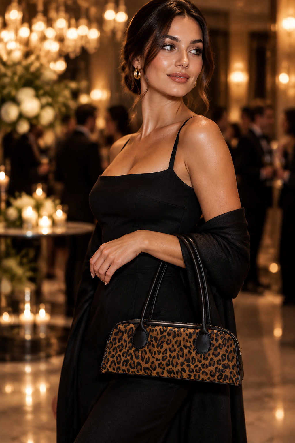 All leather handbag in leopard print with black accents and gold tone zipper.  Interior water resistant canvas in leopard print with internal slip pocket.