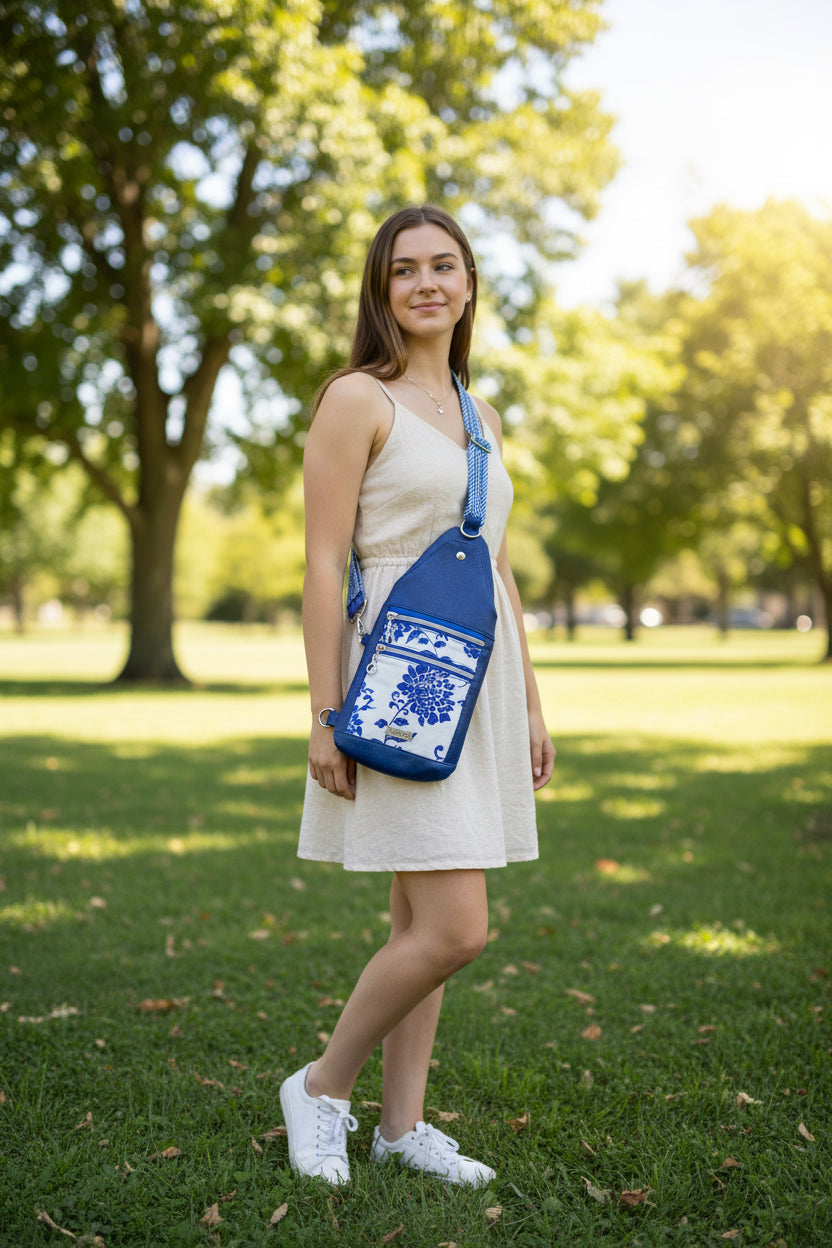 Stylish sling or crossbody in royal blue vinyl and water resistant canvas in a blue floral.  Two front zip pockets, a snap closure slip pocket and a back roomy zipper pockets.  Adjustable one and half inch coordinating strap.