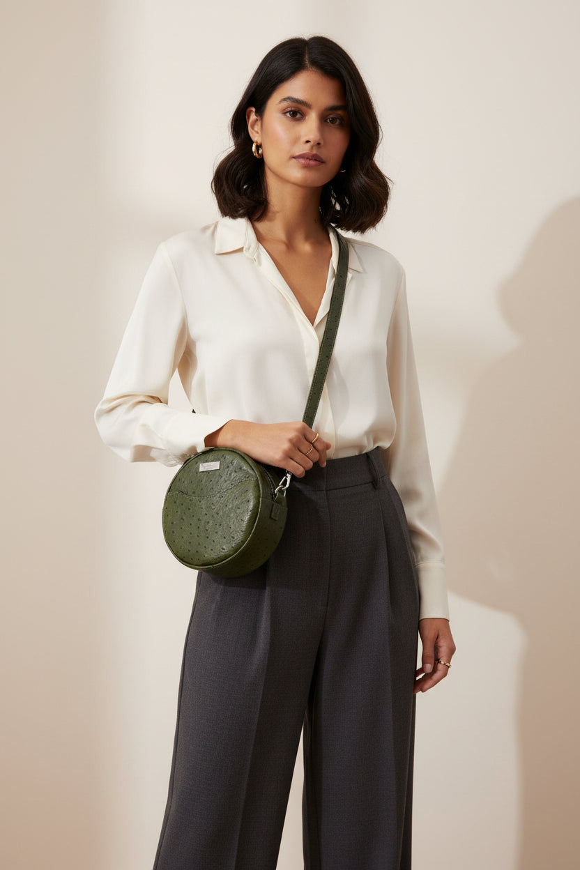 Seven inch by two inch deep crossbody bag with front slip pocket and one main zippered compartment.  Adjustable strap