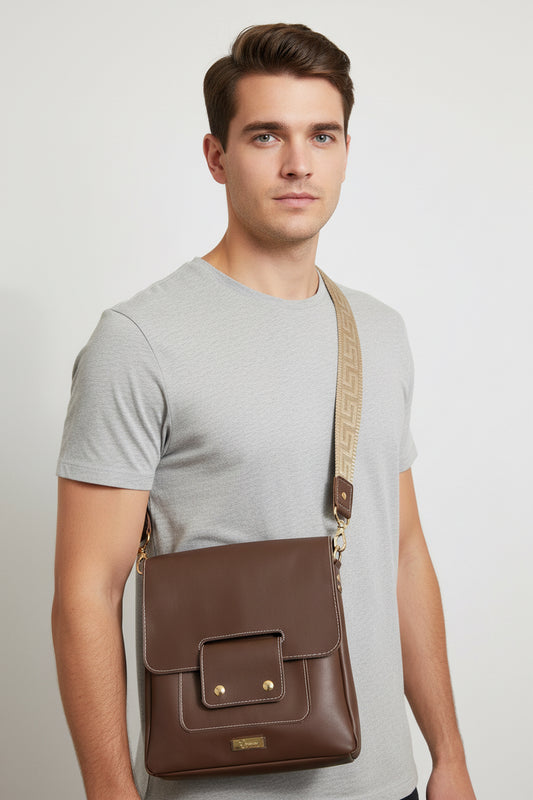 Brown leather messenger bag with double magnetic flap closure.  Two outer pockets in front and back.  1.5 inch wide deluxe strap with gold hardware.  Bag is unlined and raw edge.
