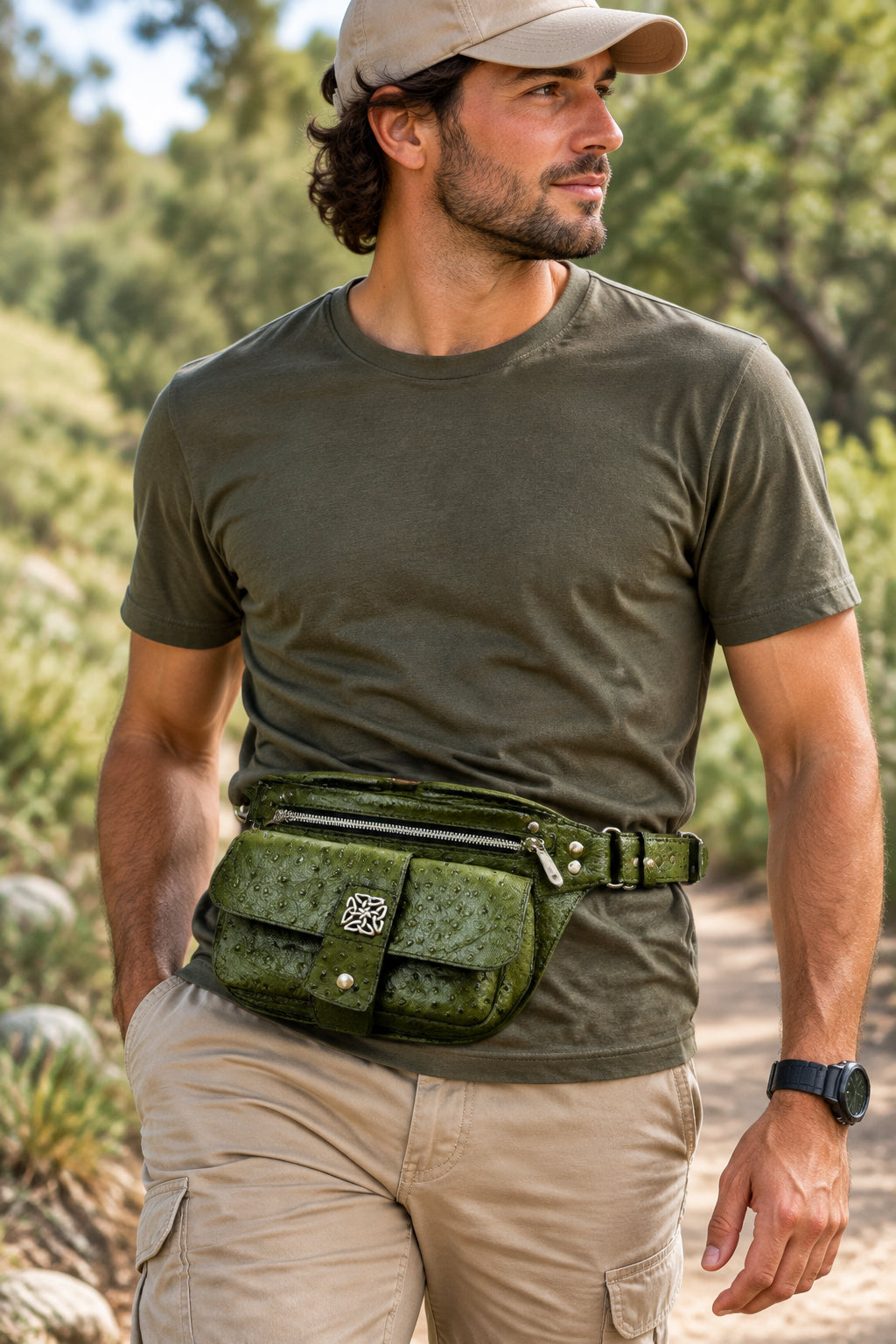 An olive green textured leather crossbody bag with a flap closure, a decorative metal emblem, a top zipper, and a matching adjustable shoulder strap, shown against a plain white background.